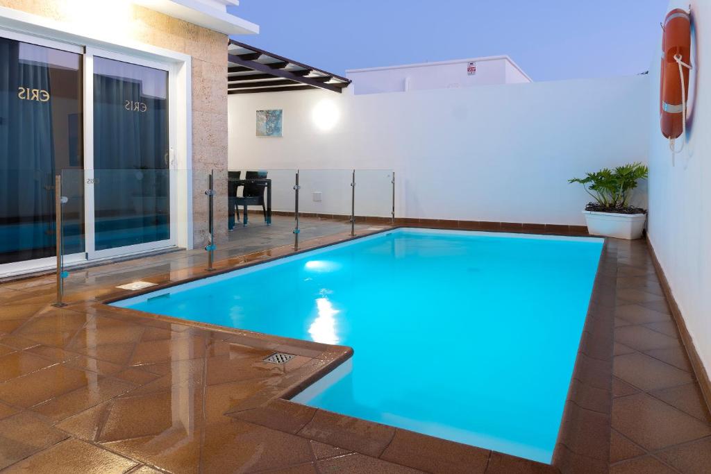 a swimming pool in the middle of a room at Villa Eris in Puerto del Carmen