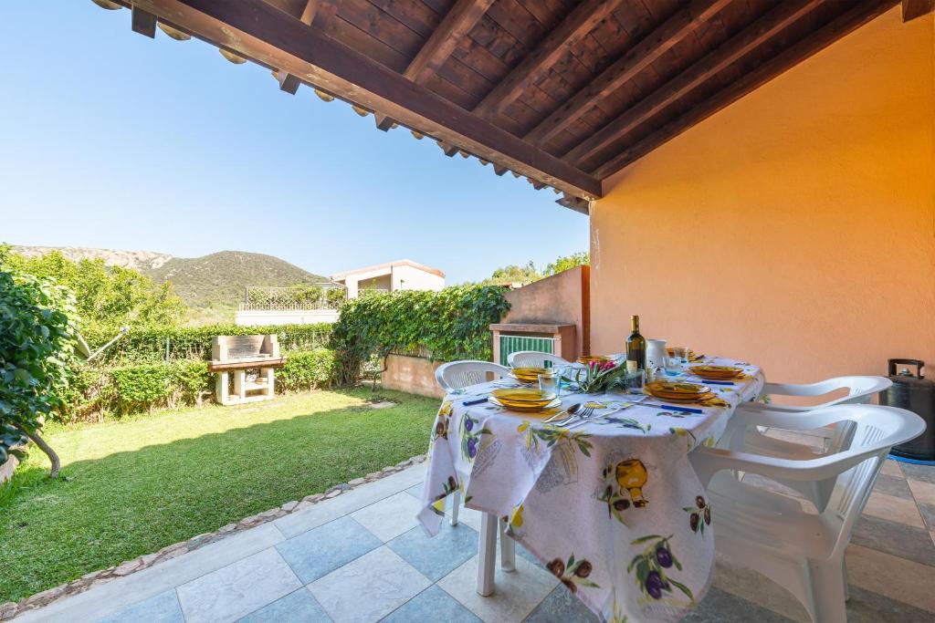 a table with a white table cloth on a patio at Villetta Stella in Chia