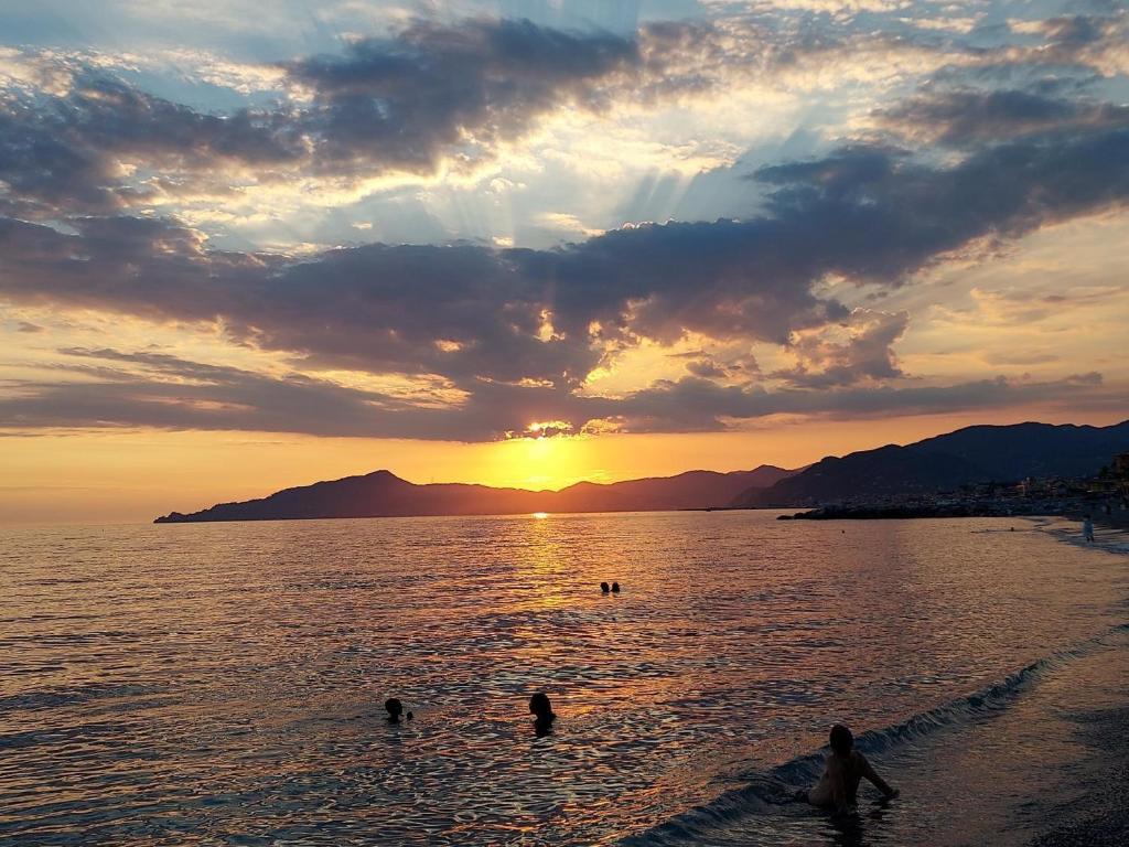 a group of people in the water at the beach at Casa Lulu' in Lavagna