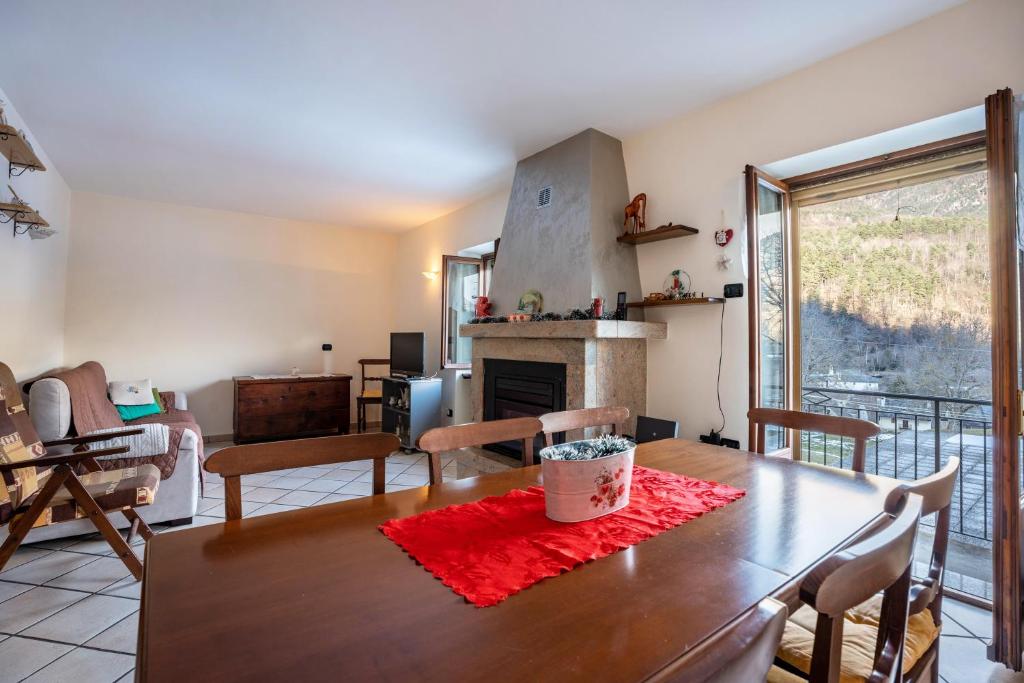 a dining room with a table and a fireplace at Casa Daniela in Druogno