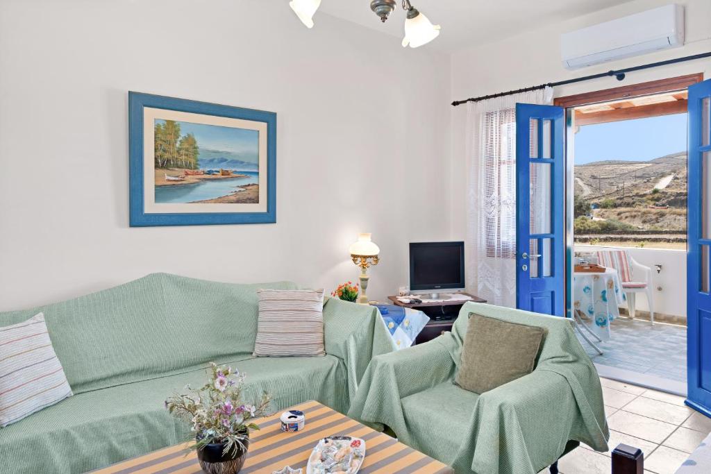 a living room with a couch and two chairs at Argyris comfy apartment in Kithnos