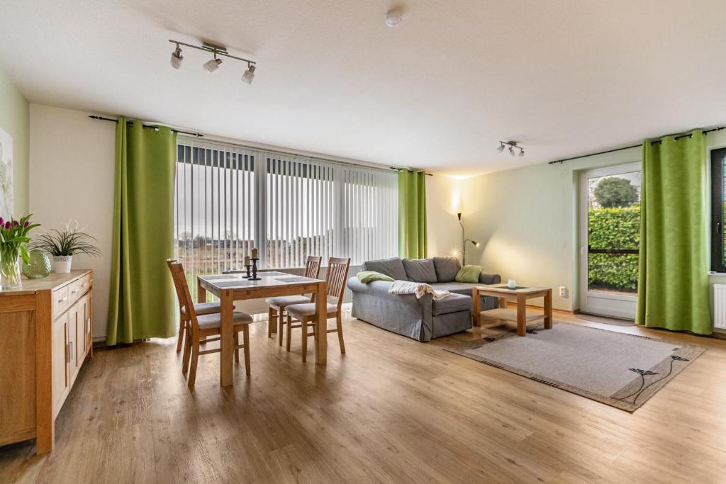 a living room with a table and a couch at Ferienhaus Dunklau in Wesselburen