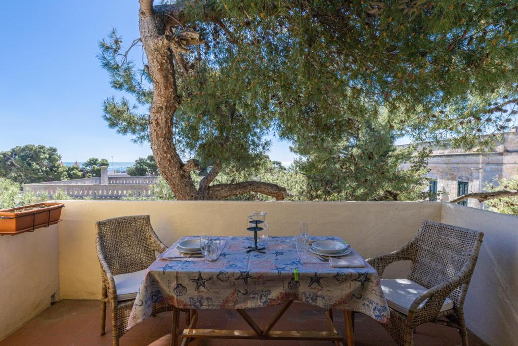a table and two chairs on a patio at Bouganville in Leuca
