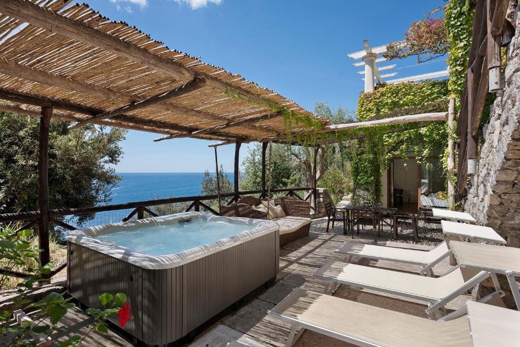 a hot tub on the patio of a house at Suite Aurora in dependance in Conca dei Marini