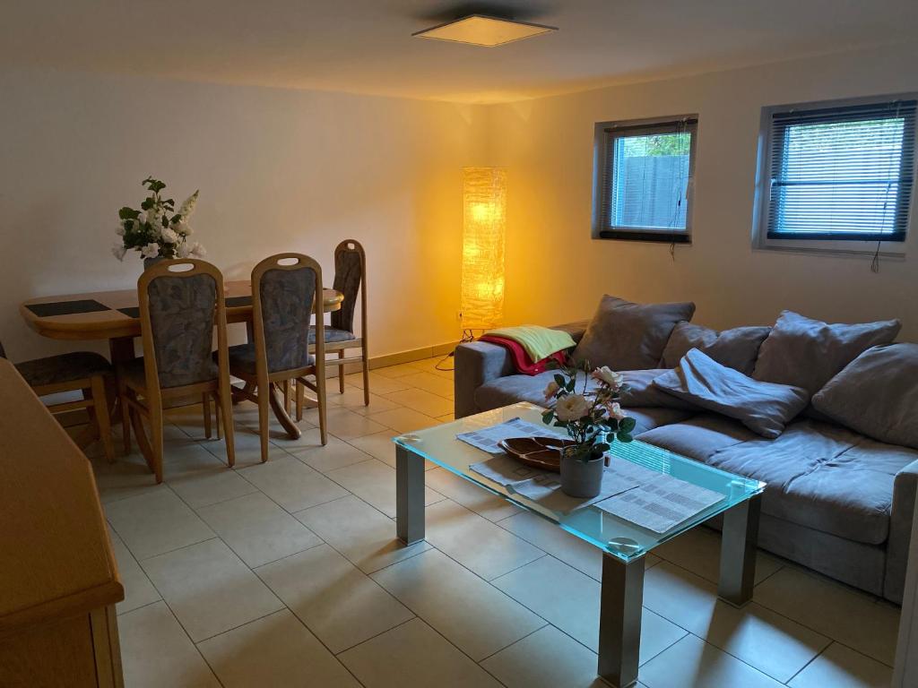 a living room with a couch and a table at Ferienwohnung Bauer in Puschendorf