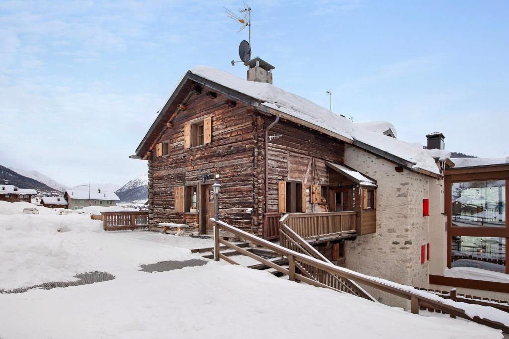 a log cabin in the snow with snow at Appartamento Gemma in Livigno
