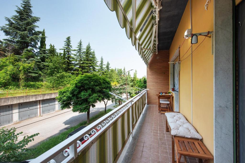 a balcony with a bench and a view of a street at La Casa Della Gioia - Serravalle in Serravalle Scrivia