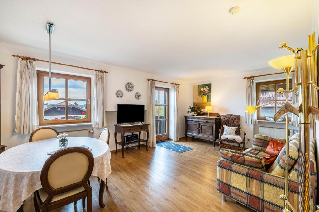 a living room with a table and a couch at Landhaus Kauderer - Wohnung 2 in Waging am See