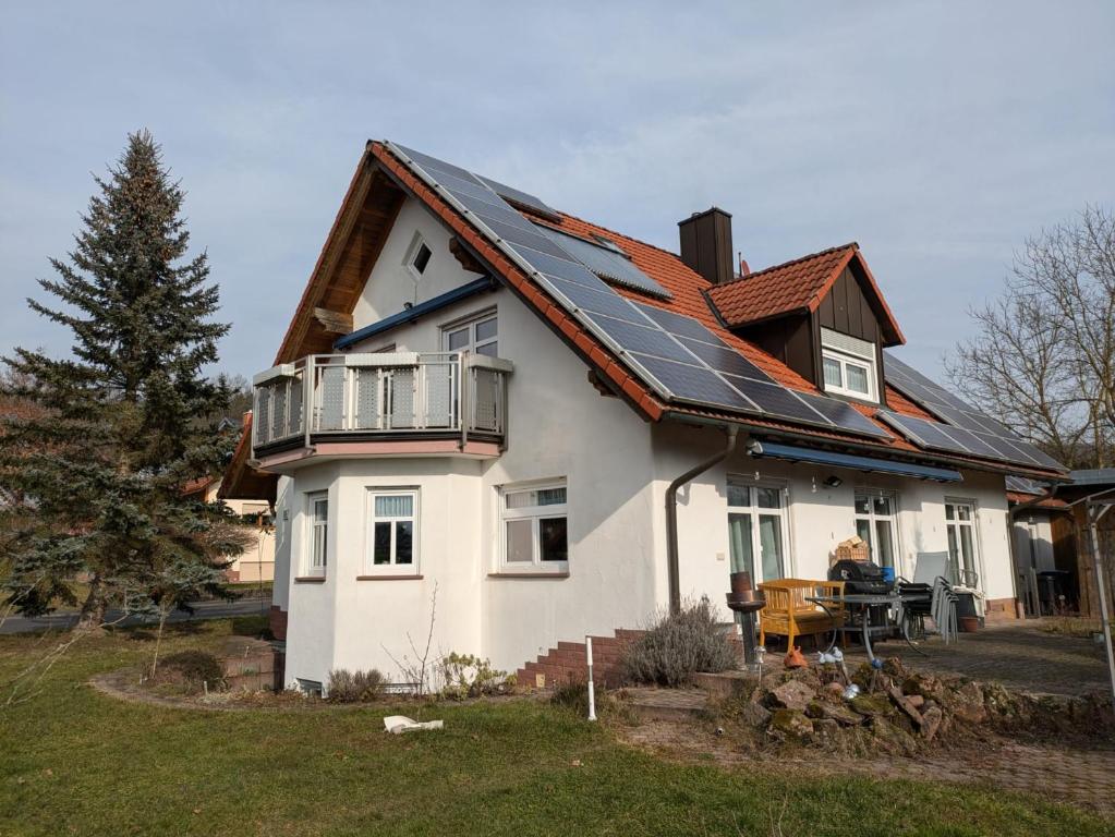 a house with a roof with solar panels on it at Ferienwohnung Dorfprozelten in Dorfprozelten