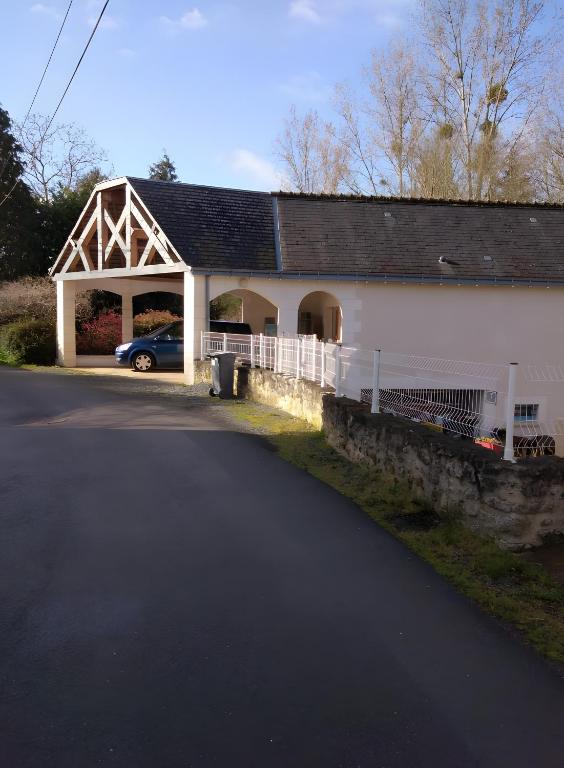a barn with a car parked in front of it at Gîte Des Caves in Civray-de-Touraine