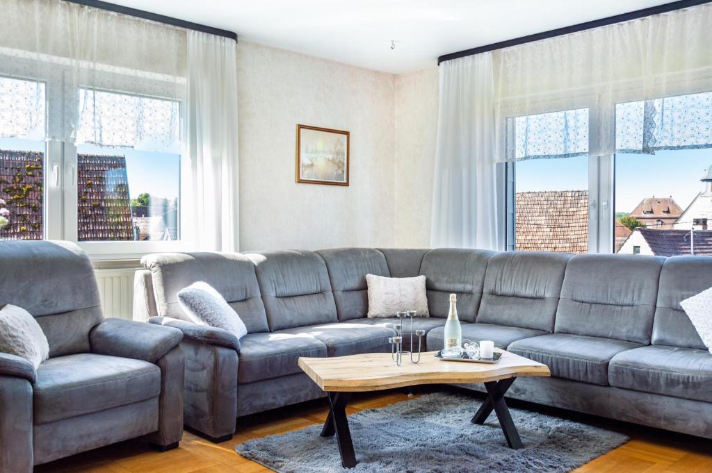 a living room with a couch and a table at Fewo Kleinert in Billingsbach