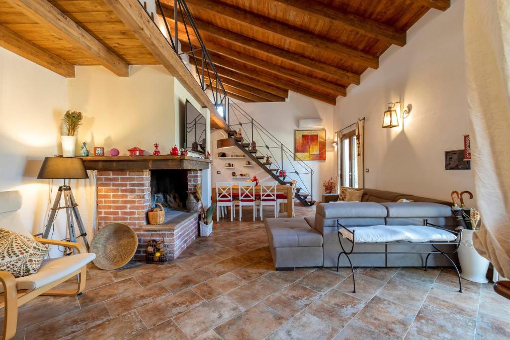 a living room with a fireplace and a staircase at La Casa di Valverde in Alghero