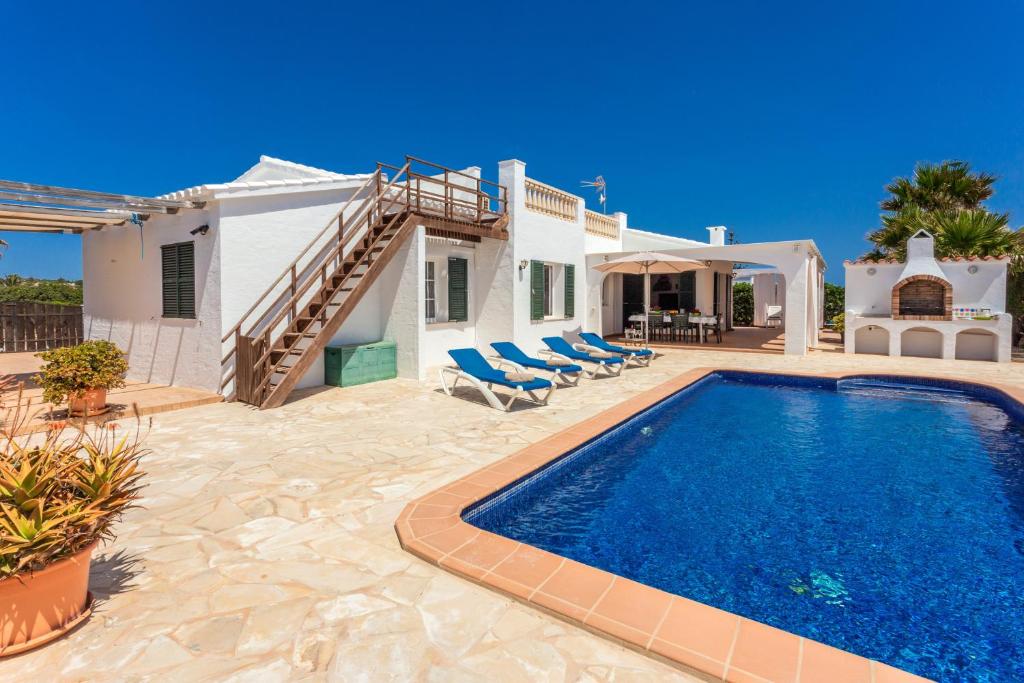a villa with a swimming pool and a house at Racó Blau in Cap d'en Font