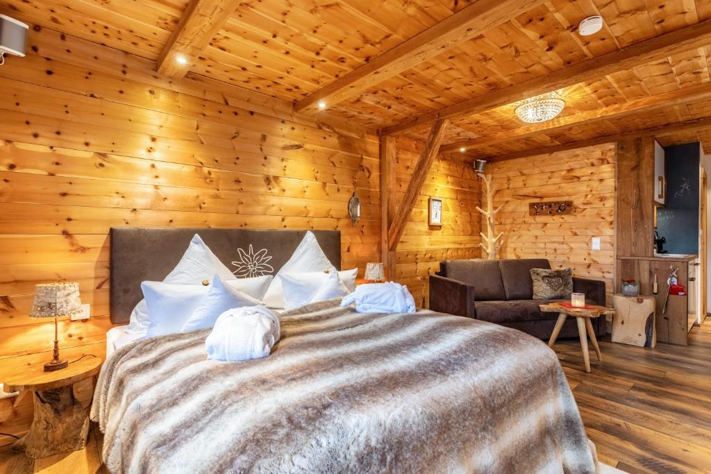 a bedroom with a large bed in a log cabin at Chalet Hüttentraum in Inzell