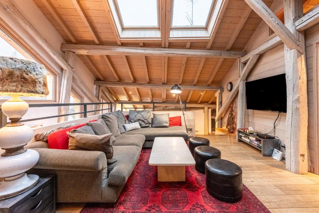 a living room with a couch and a table at Le Galetas in Brides-les-Bains