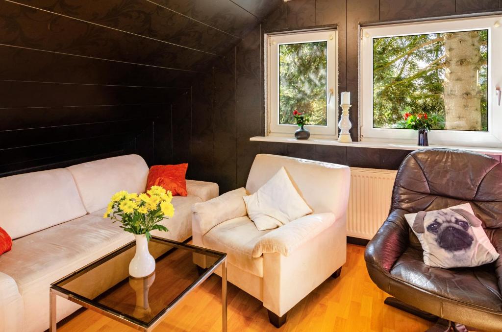 a living room with two couches and a table at Ferienwohnung Klee 2 in Fedderwarden