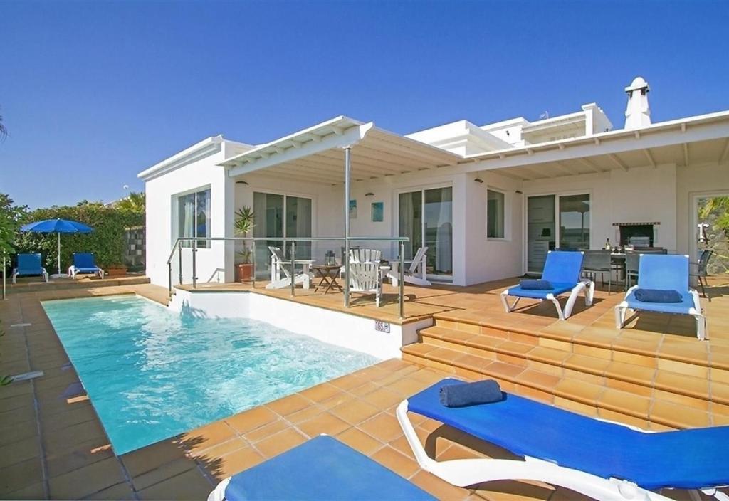 a villa with a swimming pool and a house at Villa Benedicte in Puerto del Carmen