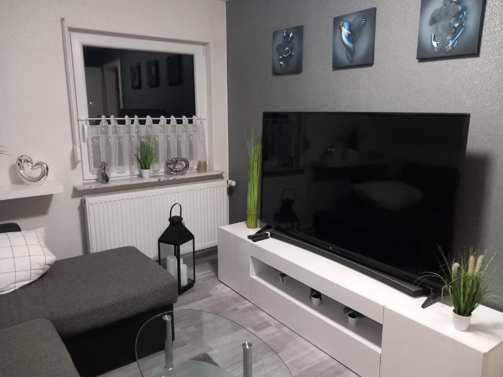 a living room with a large flat screen television at Ferienwohnung Conrads in Zetel
