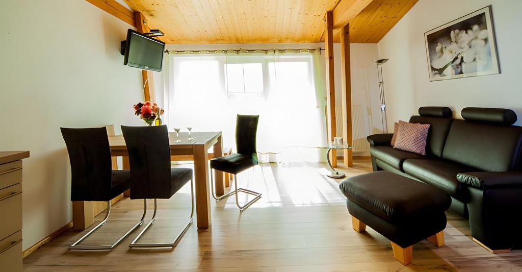 a living room with a table and a couch at Ferienwohnung Aichem in Radolfzell am Bodensee