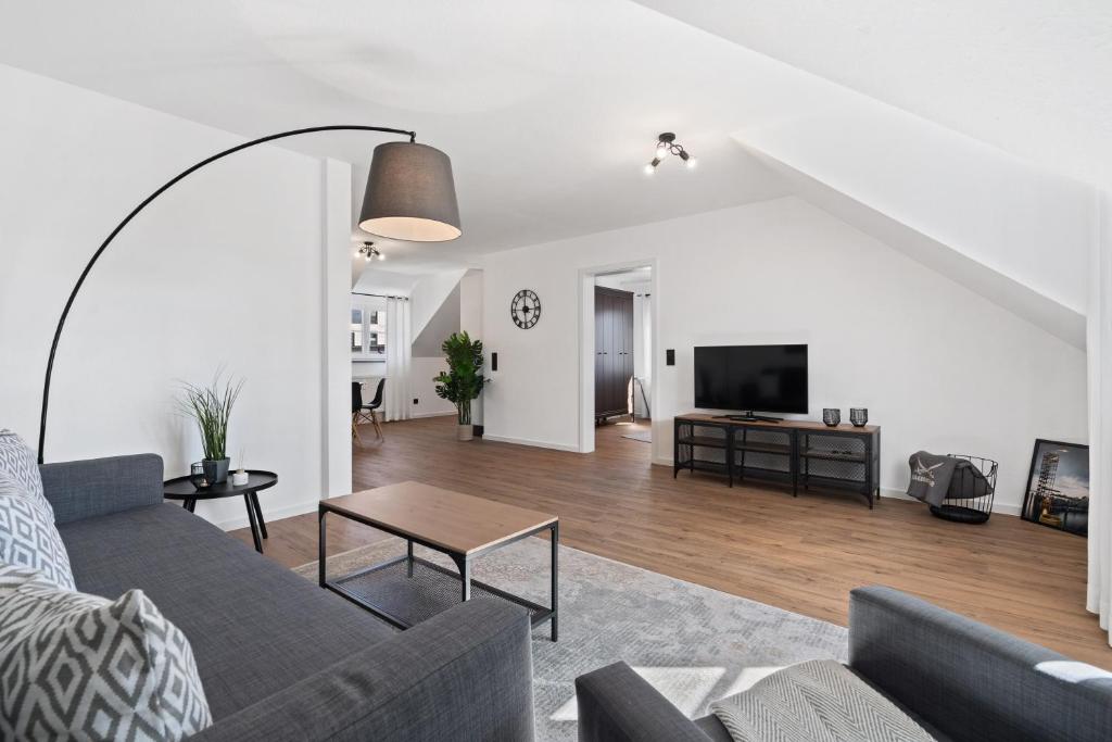 a living room with a couch and a tv at Apartment Lio - See und Zentrum in Friedrichshafen