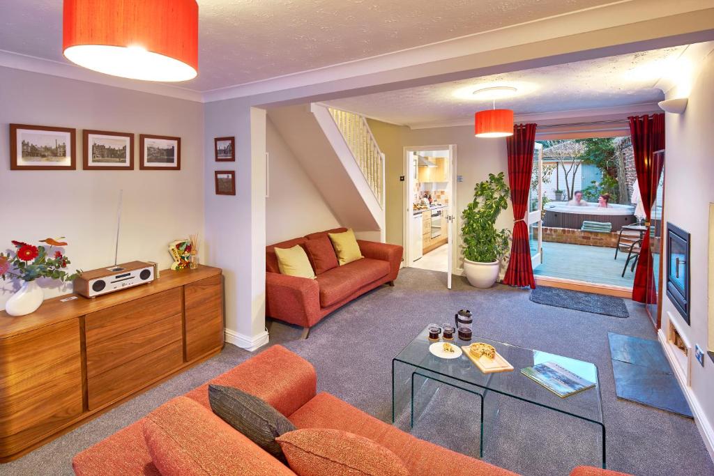 a living room with a couch and a table at Bright Moments Holiday Home in Beverley