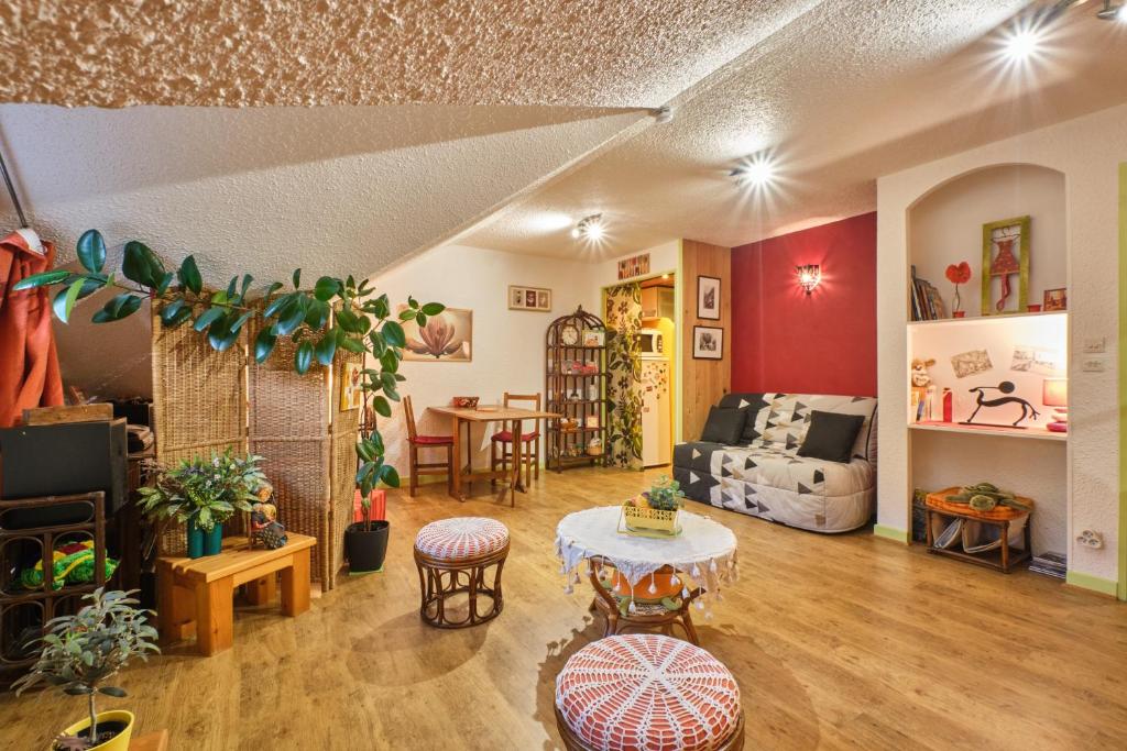 a living room with a table and a couch at L'Edelweiss in Saint-Pierre-de-Chartreuse