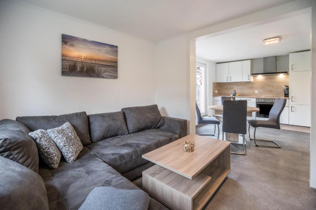 a living room with a couch and a table at Ferienwohnung 9 und 40 in Thunum