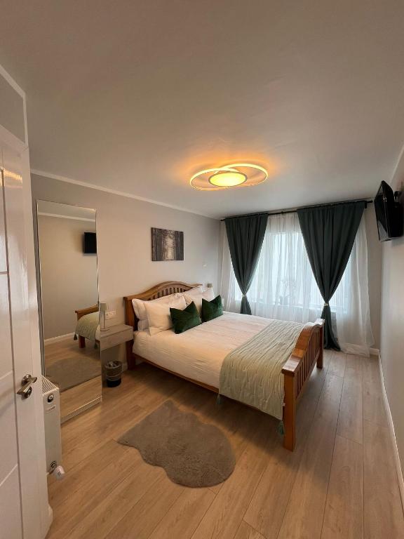 a bedroom with a large bed and a large window at Private Entrance En-suite in Gorey