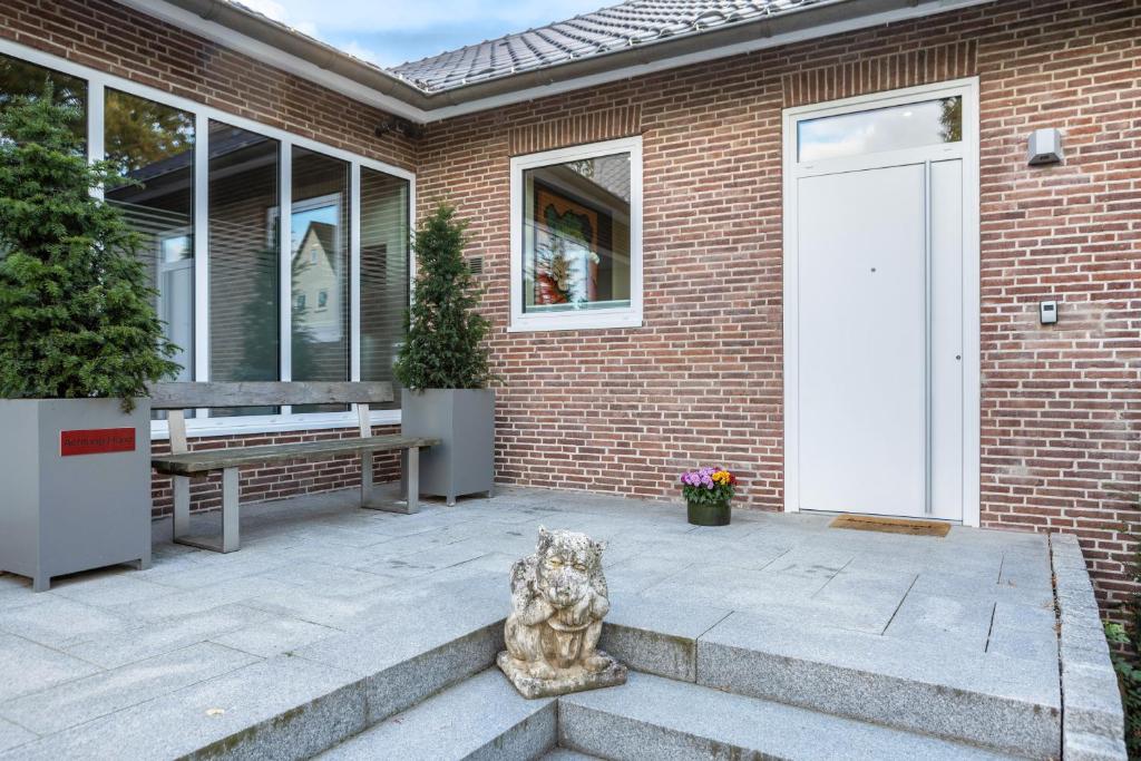 a door to a brick house with a statue in front of it at Ferienwohnung Ederweg in Wahlershausen