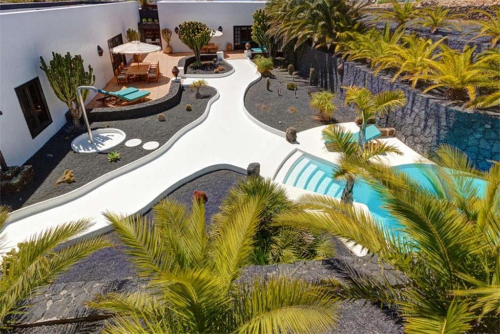 an aerial view of a resort with palm trees at Villa El Cactus in Teguise