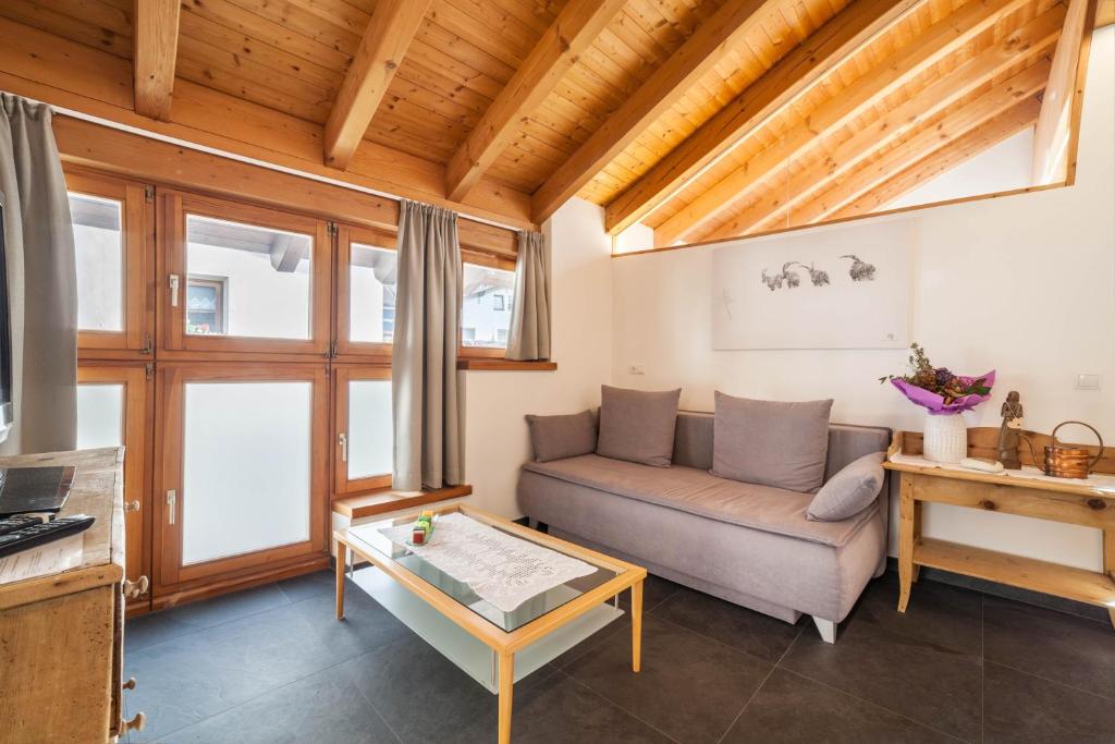 a living room with a couch and a table at Ferienwohnung Burgeis in Malles Venosta