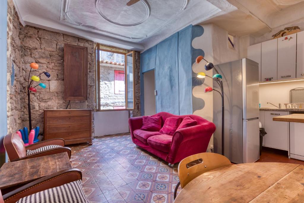 a living room with a red couch and a table at Agde Heritage, No. 16 in Agde