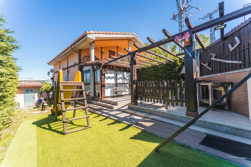 a playground in front of a house with a slide at Valle De Juarros in San Adrián de Juarros