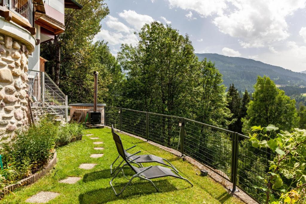 a chair sitting on the grass in a yard at Haus Auner Top 5b in Westendorf