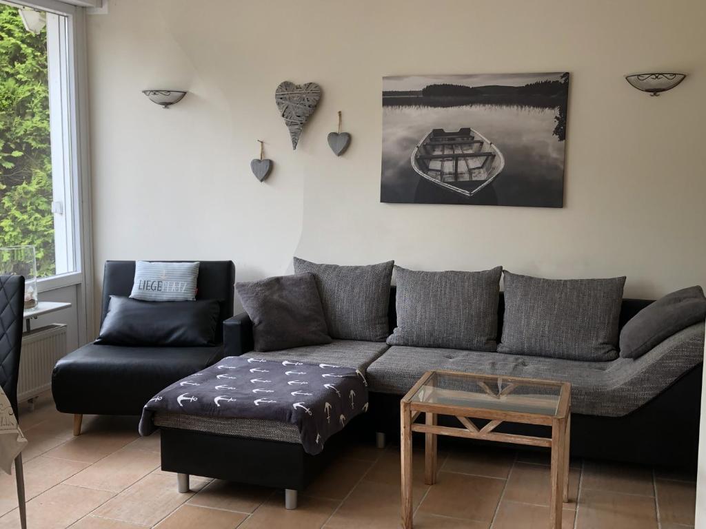 a living room with a couch and a table at Haus Piratennest in Grömitz