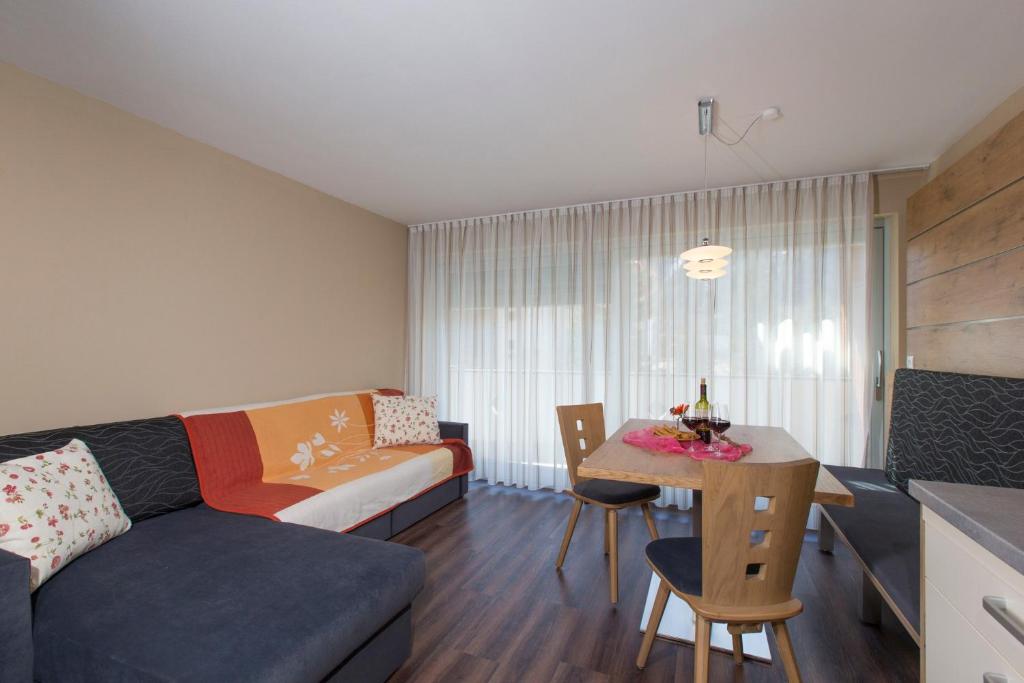 a living room with a couch and a table at Alpenblick Nr 6 in Campo Tures