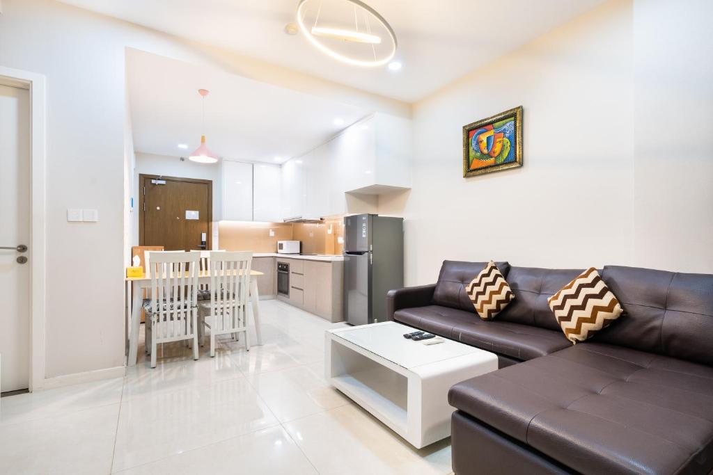 a living room with a couch and a baby crib at Boscolos Apartment in Ho Chi Minh City