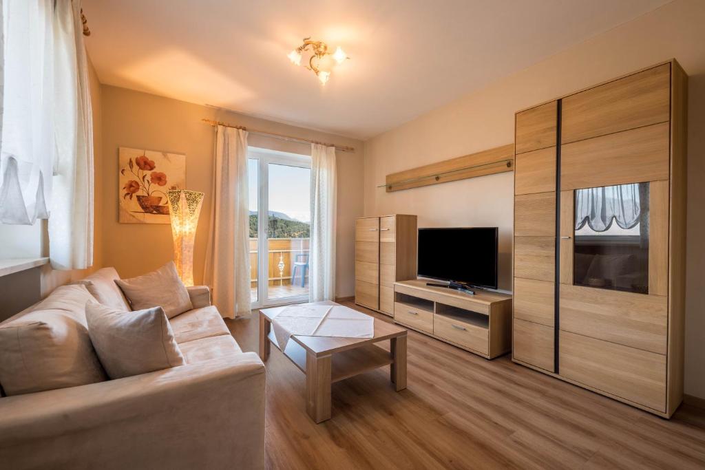 a living room with a couch and a television at Residence Kronstein - Fewo 5 in Tesimo