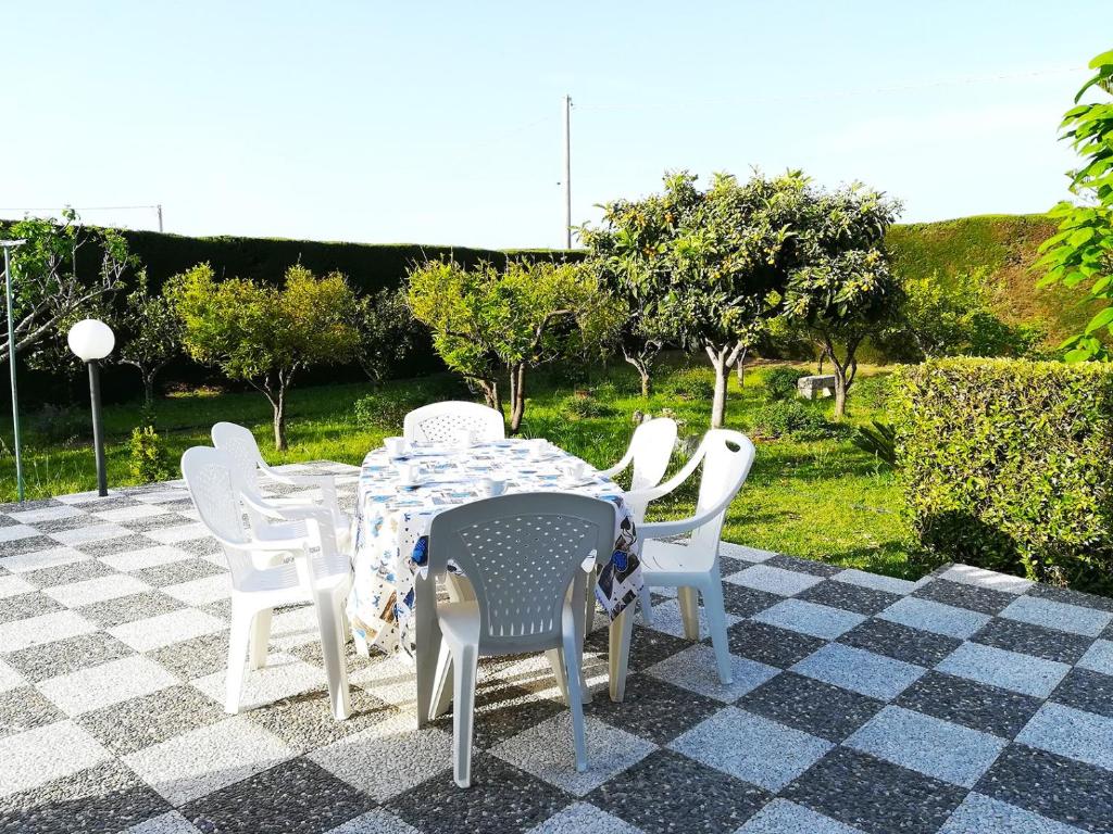 a table and chairs sitting on a checkered floor at Incantevole Villa Maddalena in Otranto