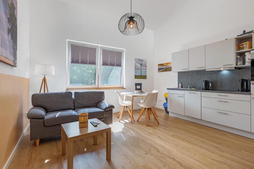 a living room with a couch and a table at Ferienwohnung Junge 3 in Lohe-Rickelshof