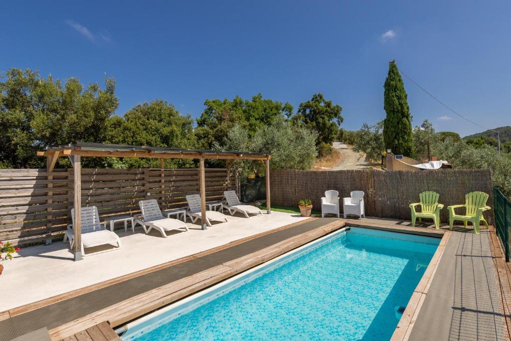 a swimming pool with lounge chairs and a swimming pool at Oltremare in Riparbella