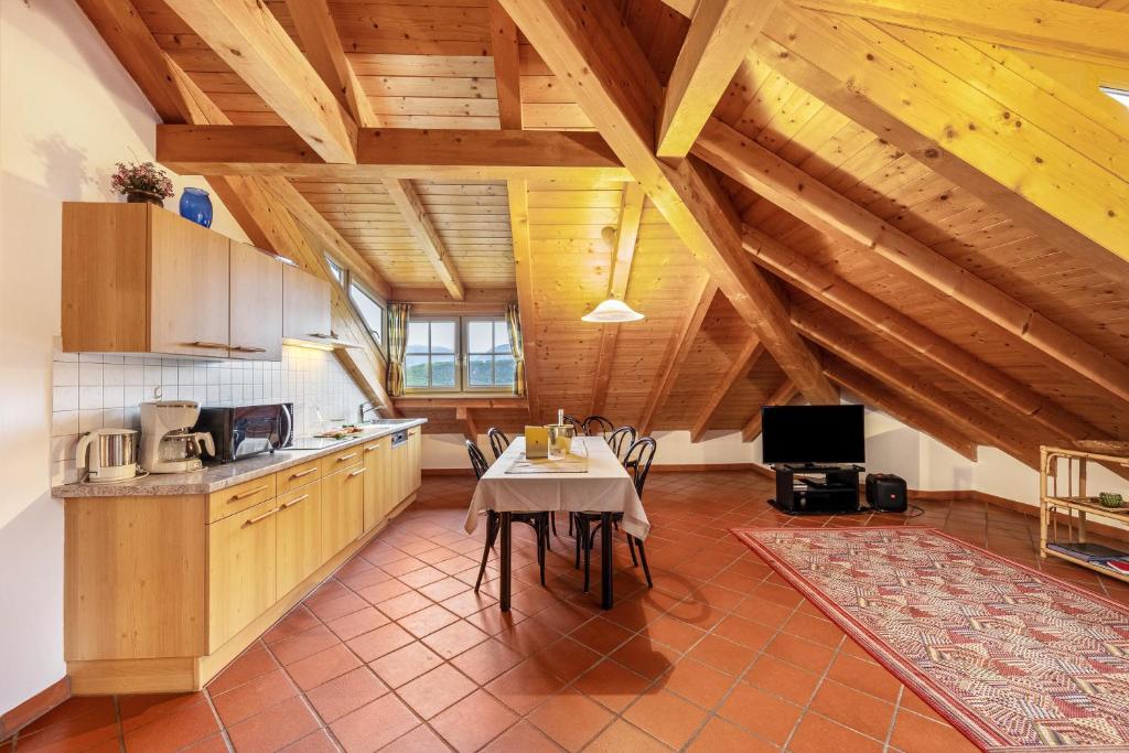 a kitchen with a table in the middle of a room at Weingut Lieselehof Apt Panorama in Caldaro