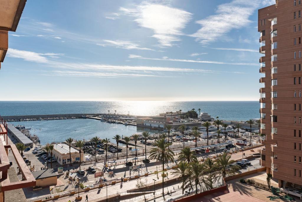 a view of a resort with a pool and the ocean at Sunny studio with seaview in Fuengirola