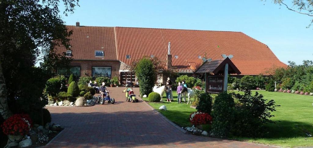 a group of people standing in front of a building at Ferienhof Renate Sassen in Werdum