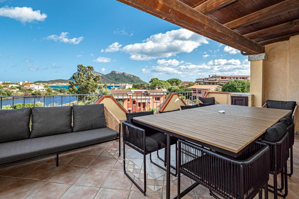 a patio with a table and chairs on a balcony at Residence Orizzonti 33 in Golfo Aranci