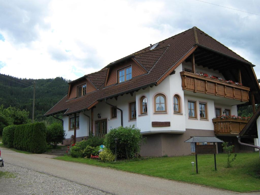 a white house with a brown roof at Faißbauernhof in Winden im Elztal