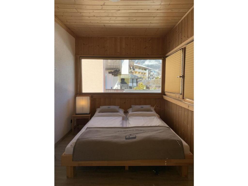 a bed in a small room with a window at Ferienwohnung Max 2 in Garmisch-Partenkirchen