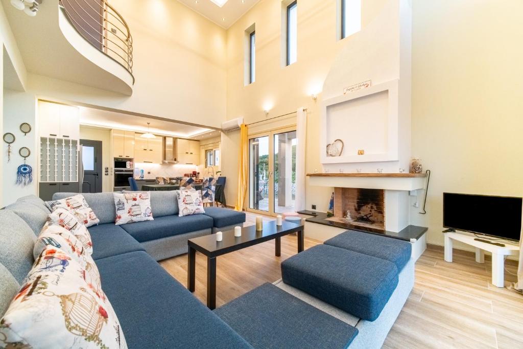 a living room with a couch and a fireplace at The Mountain Villa in Aleimmatádes
