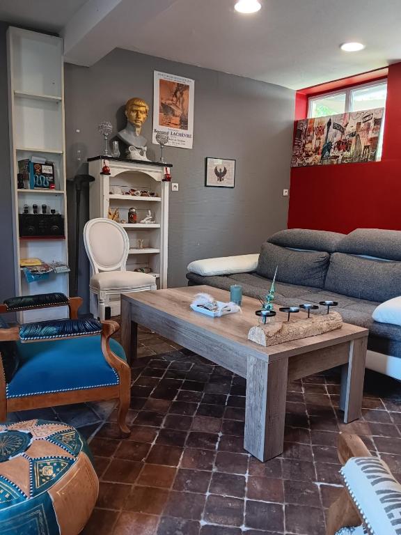 a living room with a couch and a coffee table at Maison Au Bord de l'eau in Loches
