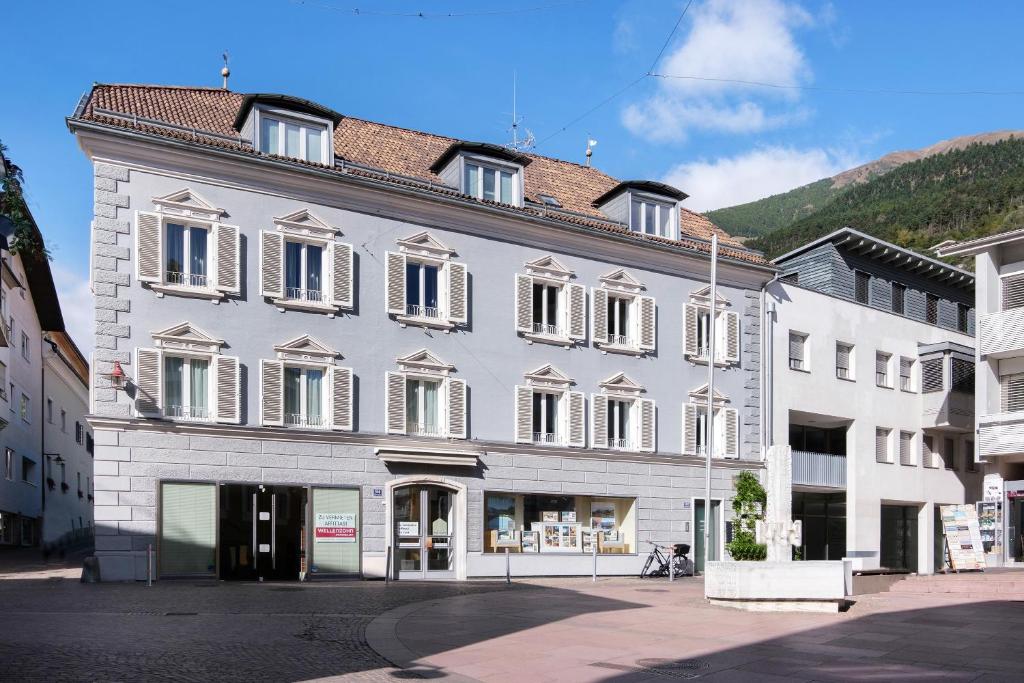 a large white building with a lot of windows at Sommavilla Apartments in Silandro